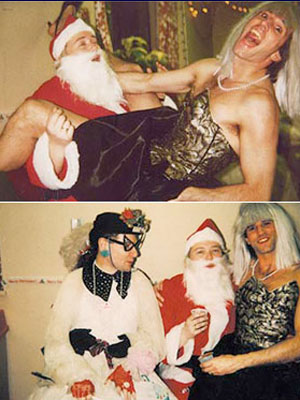 Men dressed in women's clothing sitting with Santa in sleeveless red vest.